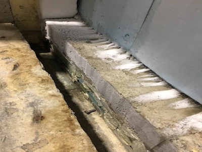 The damaged threshold area has been removed to allow for a permanent repair.