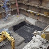 The height restrictions meant tight-sheeting could only be driven at night. Instead, Midwest REM chose an Efficiency Production manufactured Slide Rail System with integrated guard rail to shore the large excavation.