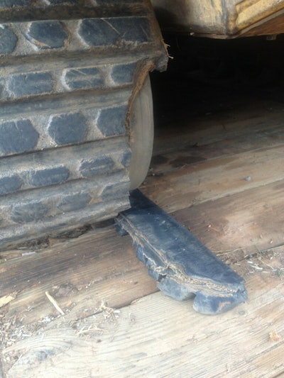 Rubber track treads accumulate cuts and missing chunks over a lifetime, but these are often cosmetic and may not affect performance. This track is still usable but should be monitored because the damage may worsen.