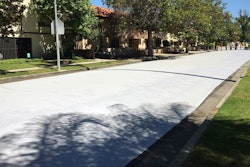 Workers apply a cool pavement coating to a street Saturday May 20, 2017 in Canoga Park. The coating is designed to reduce temperatures on the the surface of streets during Southern California heat waves.