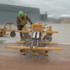 A Structural Associates crew member watches closely while operating an E-Z Drill 210-3 SRA slab rider at Westover Air Reserve Base. In all, the contractor drilled 27,000 holes as part of a project to update the base’s aircraft refueling system.