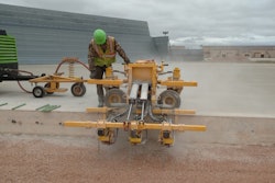 A Structural Associates crew member watches closely while operating an E-Z Drill 210-3 SRA slab rider at Westover Air Reserve Base. In all, the contractor drilled 27,000 holes as part of a project to update the base’s aircraft refueling system.