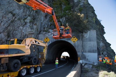 For this $6 million project, NDOT constructed a tunnel extension with a flat top filled with sand, allowing any falling rocks to nest naturally in that sand instead of falling onto the roadway.