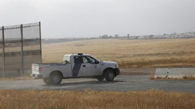 A Customs and Border Protection truck patrols the border fence east San Diego. The region has been deemed a high priority for President Donald Trump's new border wall, which is scheduled to begin construction in September. (Alejandro Tamayo / Tribune News Service)