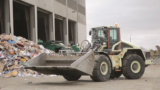 Volvo CE's LX1 prototype electric hybrid wheel loader at Waste Management's Moreno Valley Transfer Station. The LX1 is a series hybrid, which puts an electric motor at each wheel and replaces an equivalent-sized conventional loader's 13L engine with a 3.6L diesel, on board strictly to run the loader's generator. Volvo says 98% of the components on the LX1 are new.