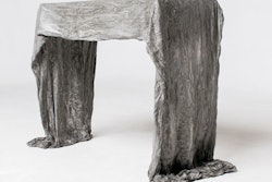 First Place Winner - Ghost Table: 'As an industrial design student, I am interested in finding new ways to use common materials. I was inspired by paper mache to rethink what concrete can do. My table is made only out of canvas soaked in a mixture of Quikrete and a cement polymer. I saturated several canvas layers and draped them over a table. When they dried I removed the inside table and was left with a new one! I was excited to make a new piece of furniture but even more excited to find a new way to look at cement and create things from it' - Joey Eddington