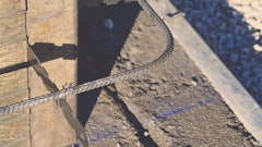 Chalk lines on the footing designate the inner formwork wall line. The width of the footing minus the wall thickness should leave enough footing along the outside to support the wall forms.
