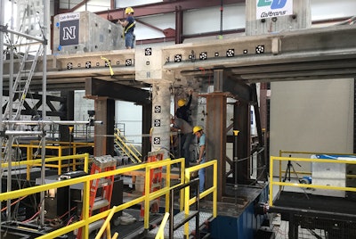 Graduate engineering students at the University of Nevada, Reno inspect damage to a 100-ton, 70-ft.-long concrete bridge that was shaken in a live simulation to test new materials, connections and construction techniques with the goal of creating safer structures and quicker rebuilding times following earthquakes.