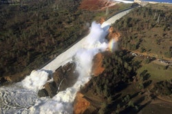 View of Oroville Dam's main spillway (center) and emergency spillway (top), February 11, 2017.