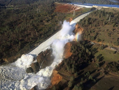 View of Oroville Dam's main spillway (center) and emergency spillway (top), February 11, 2017.