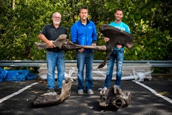 From left, Mike Siereveld, Steve Hunderman and Joe Siereveld, all partners of Eagle Creek Homes, on Wednesday, Sept. 6, 2017 hold American mastodon bones found at their Railview Ridge development, in Byron Township.