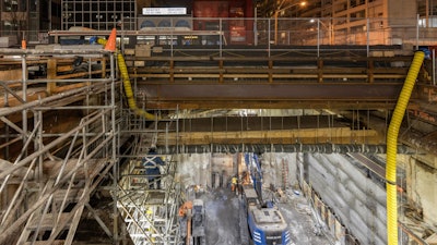 Deep Foundations Contractors kept traffic flowing on Eglinton Avenue by building a temporary bridge deck over the northern half once drilling was completed. It consisted of timber mats supported by steel beams and bracing, and locked in place with Steel Angle.