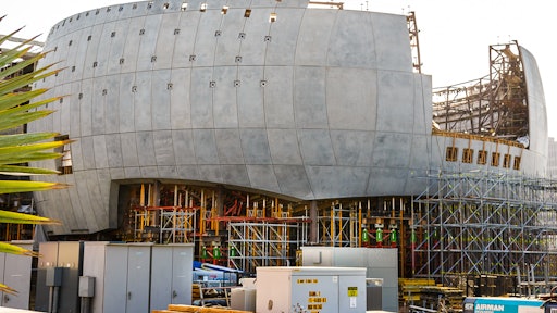 The Geffen Theater is a structural concrete sphere that will weigh 25 million pounds. The outside surface is made from precast concrete panels molded for a specific location. Two feet of highly reinforced shotcrete is placed against the precast on the inside. The penetration holes in the precast will be used to support the glass canopy mounted two feet away from the precast. The projection booth will extend out from the sphere through the large square opening. Notice the color of the shoring towers, it indicates the amount of load they can carry. .