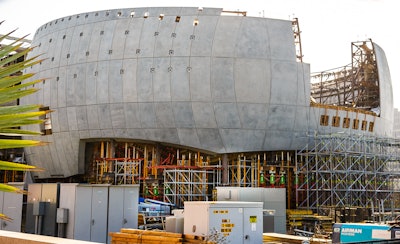 The Geffen Theater is a structural concrete sphere that will weigh 25 million pounds. The outside surface is made from precast concrete panels molded for a specific location. Two feet of highly reinforced shotcrete is placed against the precast on the inside. The penetration holes in the precast will be used to support the glass canopy mounted two feet away from the precast. The projection booth will extend out from the sphere through the large square opening. Notice the color of the shoring towers, it indicates the amount of load they can carry. .