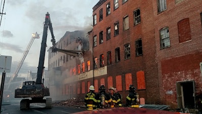 Empire Group used a Hitachi 300 65-ft. long reach excavator to assist the Reading Fire Department gain access to a fire buring in the center of an abandoned warehouse.