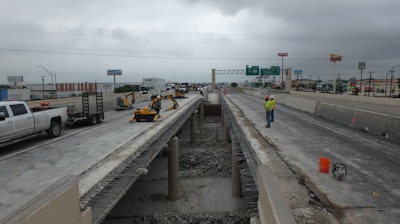 The remote-controlled Brokk 120D allowed the operator to stand about six feet away at a safe distance from flying concrete and the 20-foot drop to the road below.