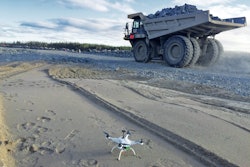 A drones crouches near a haul truck on a Bechtel project. Drones have created a competely new construciton equipment category.