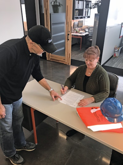Safety manager Kirk Waggoner guides Jacque Cato, safety assistant, through the company’s snow removal protocol.