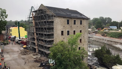The old brick facade of the existing hotel remains, while the inside was fully gutted, making concrete pumps a necessity for placing concrete.