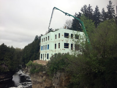 The Putzmeister 40Z-meter was set up in a precarious location to reach up and over the corner of the spa's building to pump concrete for a patio.