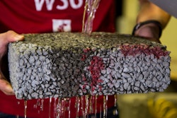 Water streams through WSU pervious pavement with carbon fiber in a lab test.
