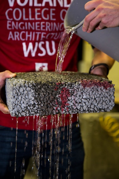 Water streams through WSU pervious pavement with carbon fiber in a lab test.