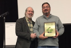 Ranger Kidwell-Ross (left) presents the WSA Award of Excellence in Power Sweeping to Michael Nawa.
