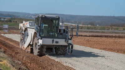 The Wirtgen soil stabilizers poured 110 to 165 pounds of a lime-cement mixture into every square meter of soil in each layer.
