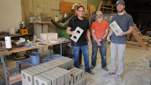 Washington State University team Jose Becerra, David Drake and Jacob Sauer (left to right) display brick they have made from drywall construction waste.