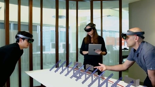 Using Azure infrastructure, HoloLens technology, and Cognitive Services, multiple users can interact with a holographic representation of the stadium data and digitally track actual construction progress in context of the Synchro 4D construction model.