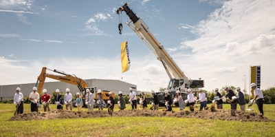 With shovels in hand, Mrs. Sophie Albrecht, Jan Liebherr, Liebherr USA, Co. Managing Directors, its building partners and government officials broke ground during the ceremony. From left: Terrence Leo, Cort Reiser (Liebherr Mining Equipment Newport News, Co), Dave France (Kimley-Horn & Associates, Inc.), Michael Molzahn (HBA Architecture & Interior Design, Inc.), Peter Mayr, Managing Director, Cheri Cook, Finance Director (Liebherr USA, Co.) Gary Minter, Sharon Scott, Florence Kingston, Tina Vick (Newport News City Officials), Jan Liebherr, Mrs. Sophie Albrecht (Administrative Board, Liebherr-International AG), McKinley Price, Mayor, city of Newport News, Ms. Charlotte Liebherr, Torben Reher, Daniel Pitzer (Managing Directors of Liebherr USA, Co.), Michael Daniels, Danny Lee and John Lawson (WM Jordan), Juergen Mayer, Liebherr Purchasing Services GmbH.
