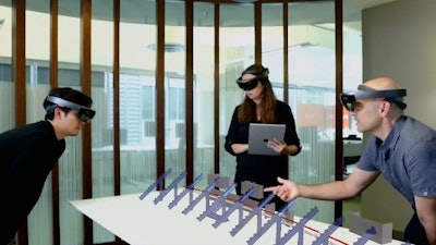 Using Azure infrastructure, HoloLens technology, and Cognitive Services, multiple users can interact with a holographic representation of the stadium data and digitally track actual construction progress in context of the Synchro 4D construction model.