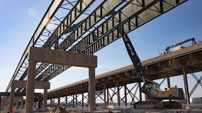 Greg Bair Track Hoe Service used the Volvo EC480 HR high-reach excavator on both land and water during the demolition of the Interstate 70 westbound bridge outside downtown Kansas City, KS.