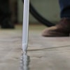 Today's joint fillers are intentionally over-applied in warehouse and industrial applications, and flush-trimmed with a floor razor to keep out debris and protect slab edges from spalling.