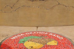 Boulders, tribal mosaics, a stencil of the school mascot and resurfaced athletic courts were installed by volunteers as part of the $250,000 landscape rehab. Pictured is Byron and Chris Klemaske, both with T.B. Penick & Sons, San Diego.