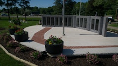 The completed Veteran’s Memorial contrasts the starkness of concrete and polished granite with the vitality of landscape in a solemn, reflective setting.