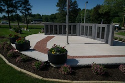 The completed Veteran’s Memorial contrasts the starkness of concrete and polished granite with the vitality of landscape in a solemn, reflective setting.