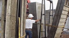 A crane delivers forms to the jobsite.