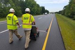 Operators scan a pavement section. Readings are processed as a line chart.