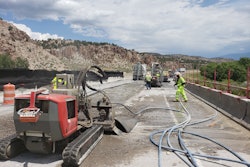 Crews direct Aqua Cutters to remove 4 inches of the 8-inch bridge deck concrete with 20,000 psi water jets, leaving one inch between the remaining concrete and the rebar.