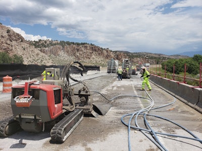 Crews direct Aqua Cutters to remove 4 inches of the 8-inch bridge deck concrete with 20,000 psi water jets, leaving one inch between the remaining concrete and the rebar.