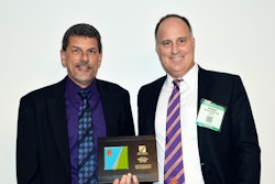 At FP2 board meeting Jan. 15, incoming president Scott Bergkamp, president, Bergkamp Inc. (left), offers token of appreciation to outgoing president Andrew Crow, vice president, pavement technologies, Ingevity