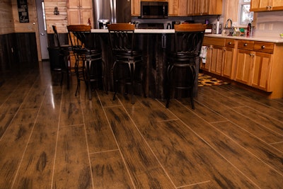 Homeowners who build on concrete slabs can now achieve the look of wood thanks to Kasella's artistry. Grain design for each plank is applied by hand.