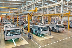 The mobile cranes are produced in a 400-meter-long production hall. In the foreground, employees carry out the final assembly of the mobile crane undercarriage.