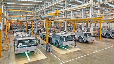 The mobile cranes are produced in a 400-meter-long production hall. In the foreground, employees carry out the final assembly of the mobile crane undercarriage.
