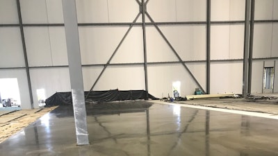 Columns shrink wrapped and end wall protected during concrete placement.