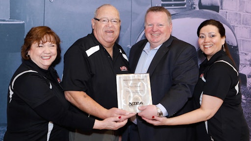 Accepting the award for Flaps Up from NTEA President & CEO Steve Carey (second from right) are, from left to right: Maureen Earp Wood, Jerry Proctor and Judy M. Turner.