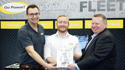 Accepting the award for Go Power! from NTEA President & CEO Steve Carey (at right) are, from left to right: Ray Collett and Eric Starling.