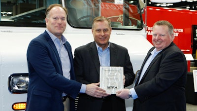 Accepting the award for Morgan Olson from NTEA President & CEO Steve Carey (at right) are, from left to right: Rich Tremmel, Vice President of Sales & Marketing, and Dan DesRochers, Chief Operating Officer.