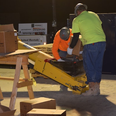 Steel fibers being loaded onto conveyor.